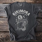 Dark gray Comfort Colors t-shirt with Kikimora slavic folklore spirit design.