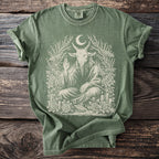 Green t-shirt with Baphomet, moon, moths, roses, and candles graphic design.