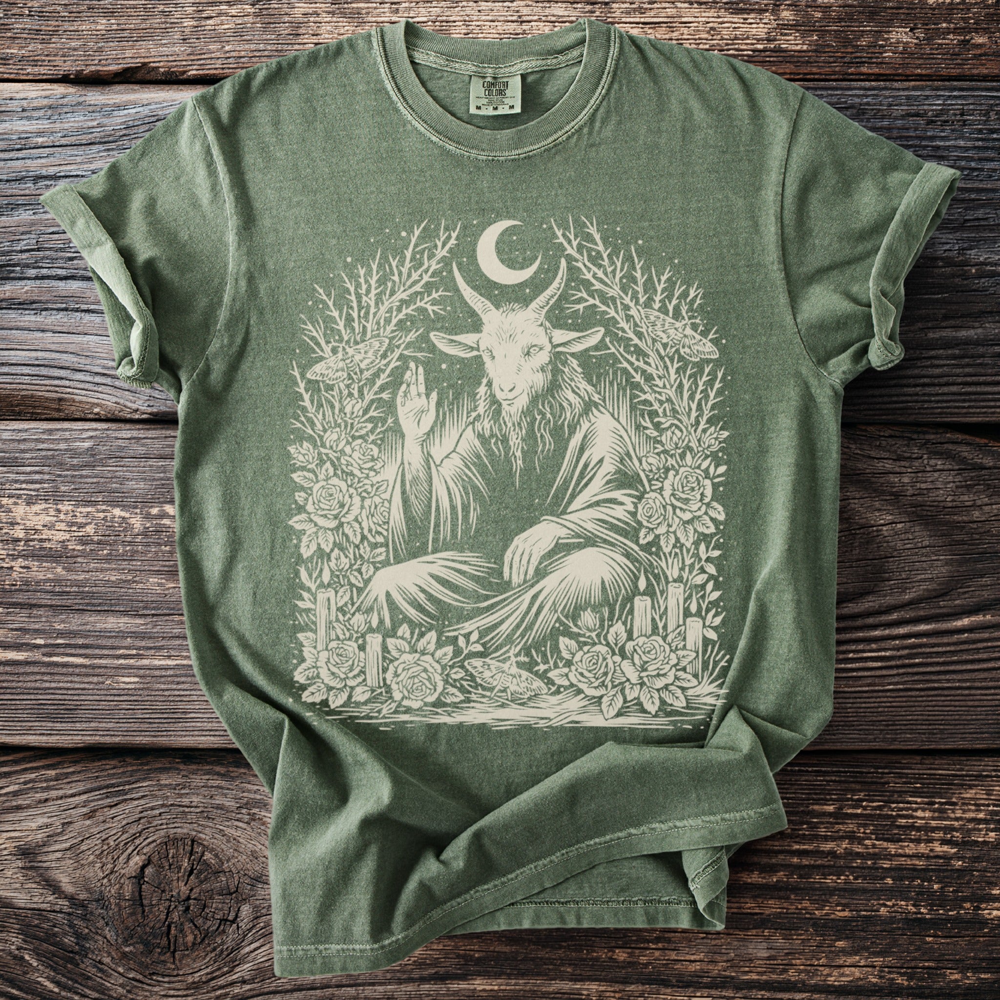 Green t-shirt with Baphomet, moon, moths, roses, and candles graphic design.