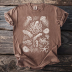 Brown t-shirt with white line art of various sea creatures and shells.