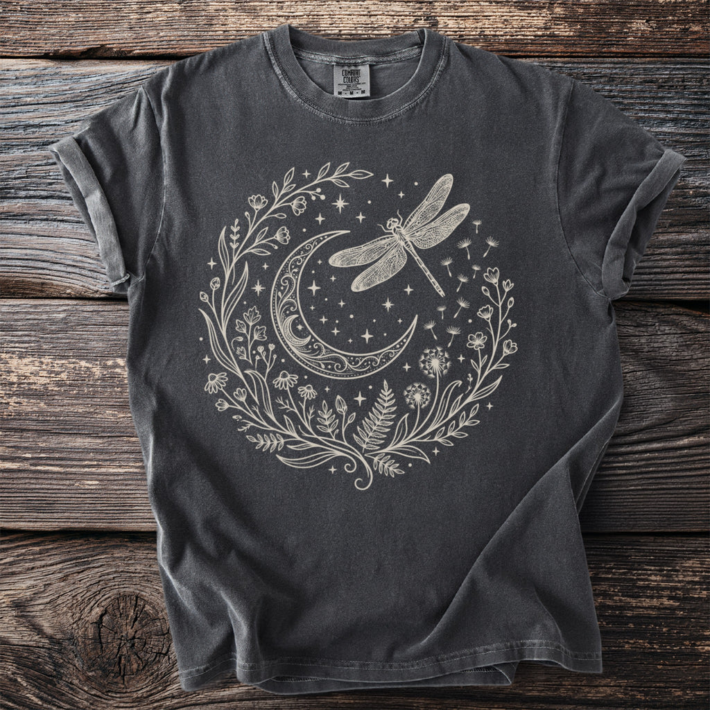 Dark grey t-shirt with a cream-colored design of a crescent moon, dragonfly, and floral elements.