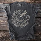 Dark grey t-shirt with a cream-colored design of a crescent moon, dragonfly, and floral elements.