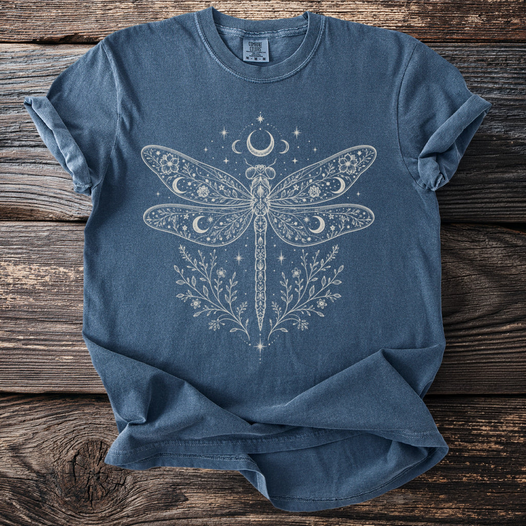 Blue t-shirt with linework dragonfly, moons, stars, and floral design.