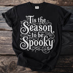 Black t-shirt with white text "Tis the Season to be Spooky" and bats.