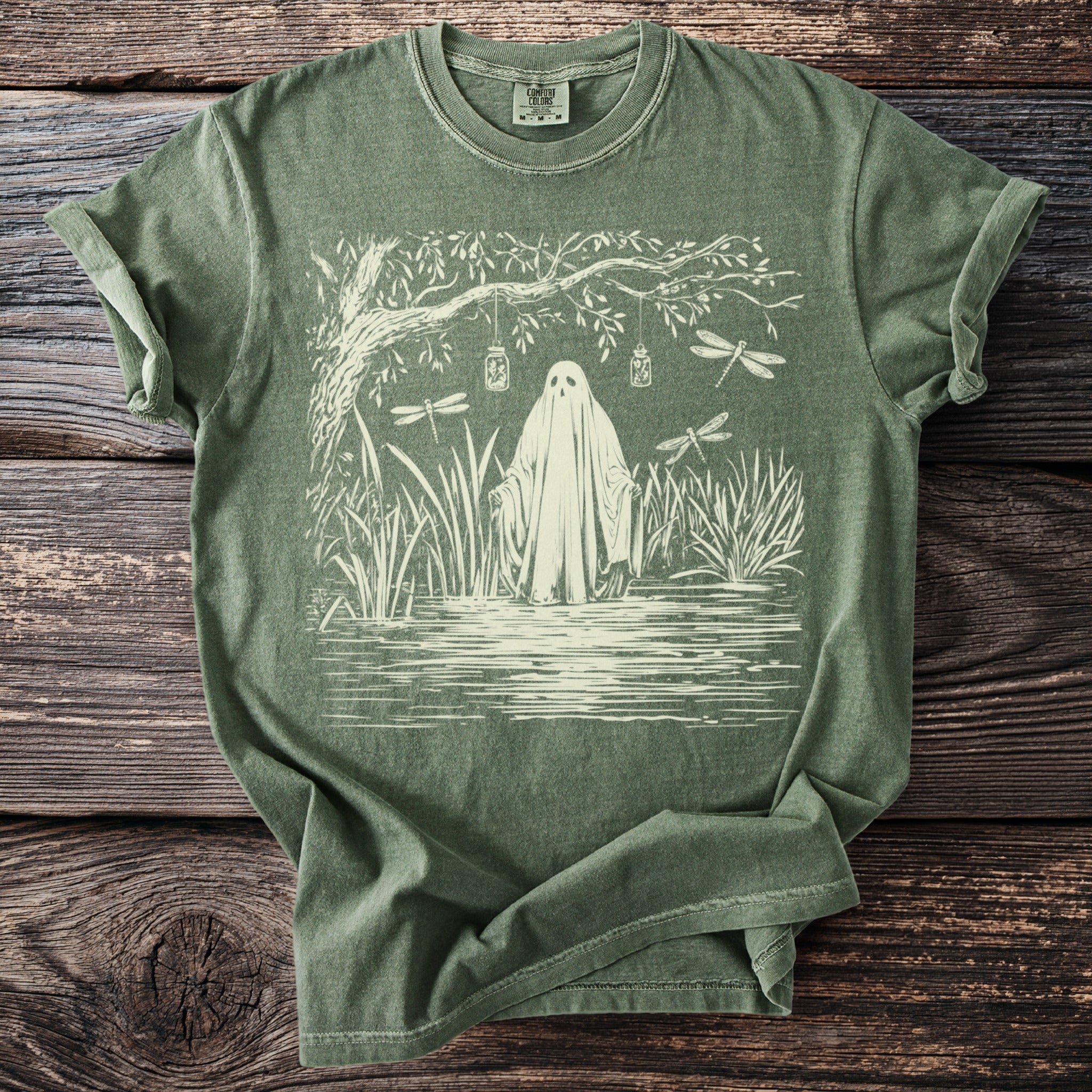 Ghost in marsh with dragonflies and hanging jars art on olive green t-shirt.