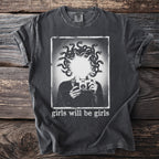 Dark gray t-shirt with graphic of Medusa holding a camera, text "girls will be girls."