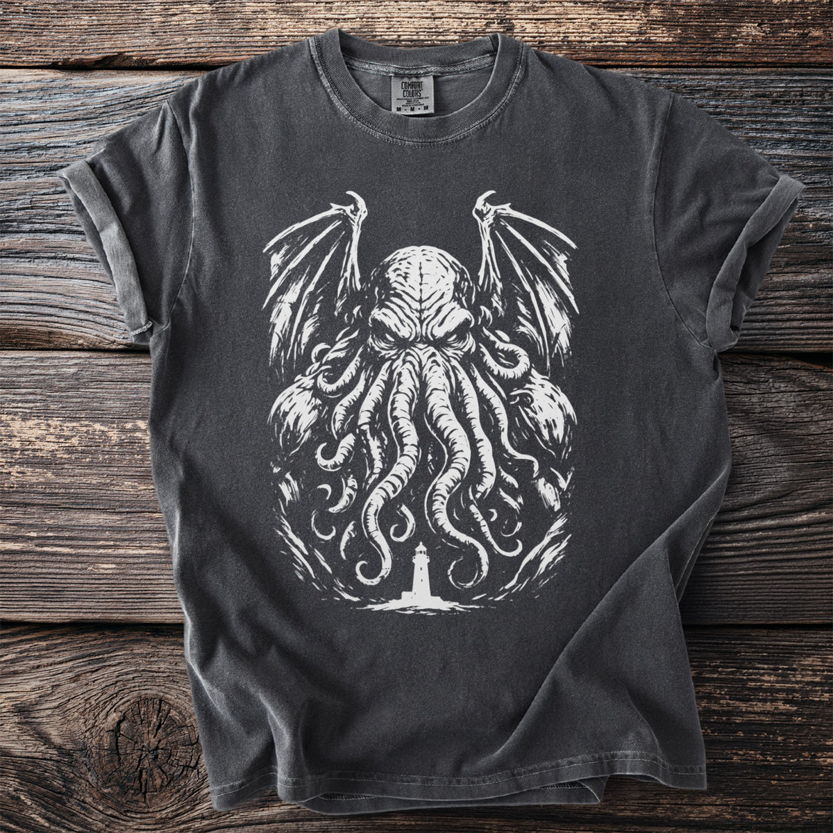 Dark grey t-shirt with a white graphic of a tentacled creature over a lighthouse.