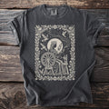 Dark gray t-shirt showing Frigg at a spinning wheel with birds and constellations.