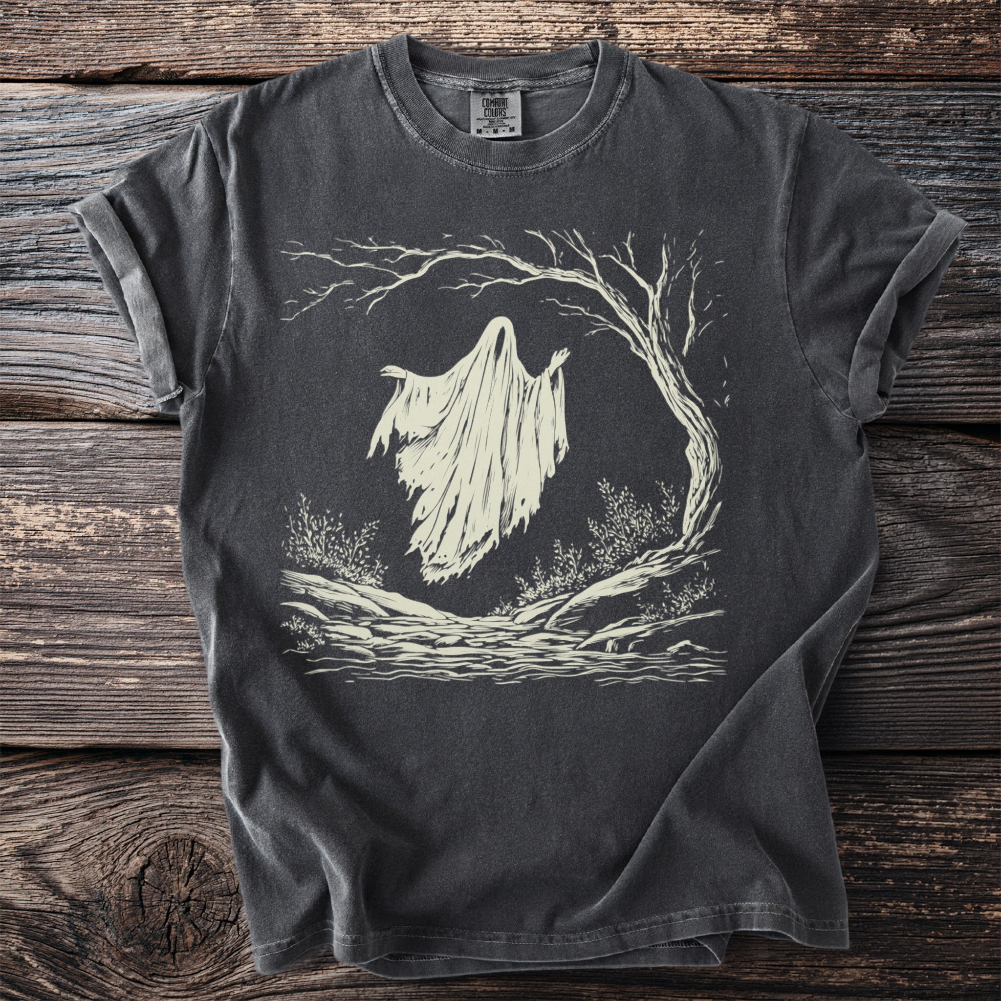 Dark grey t-shirt with a cream graphic of a ghost floating near a tree.