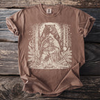 Brown t-shirt with a graphic of a Viking and a bear surrounded by trees and runes.