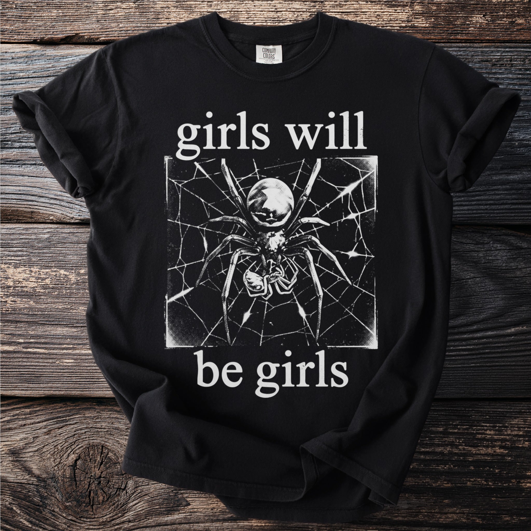 Black t-shirt with a spider on a web and text "girls will be girls".