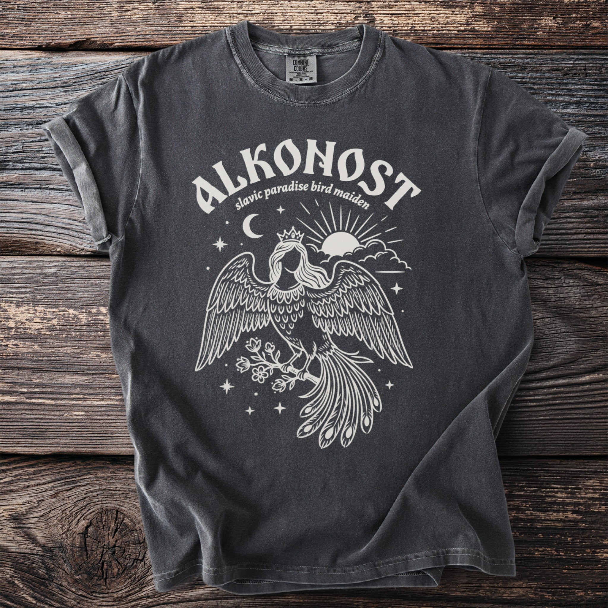 Alkonost Slavic paradise bird maiden graphic t-shirt with sun, moon, and stars.