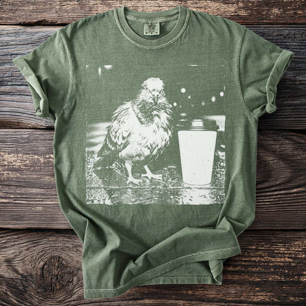 Olive green Comfort Colors t-shirt with graphic of a pigeon and a coffee cup.