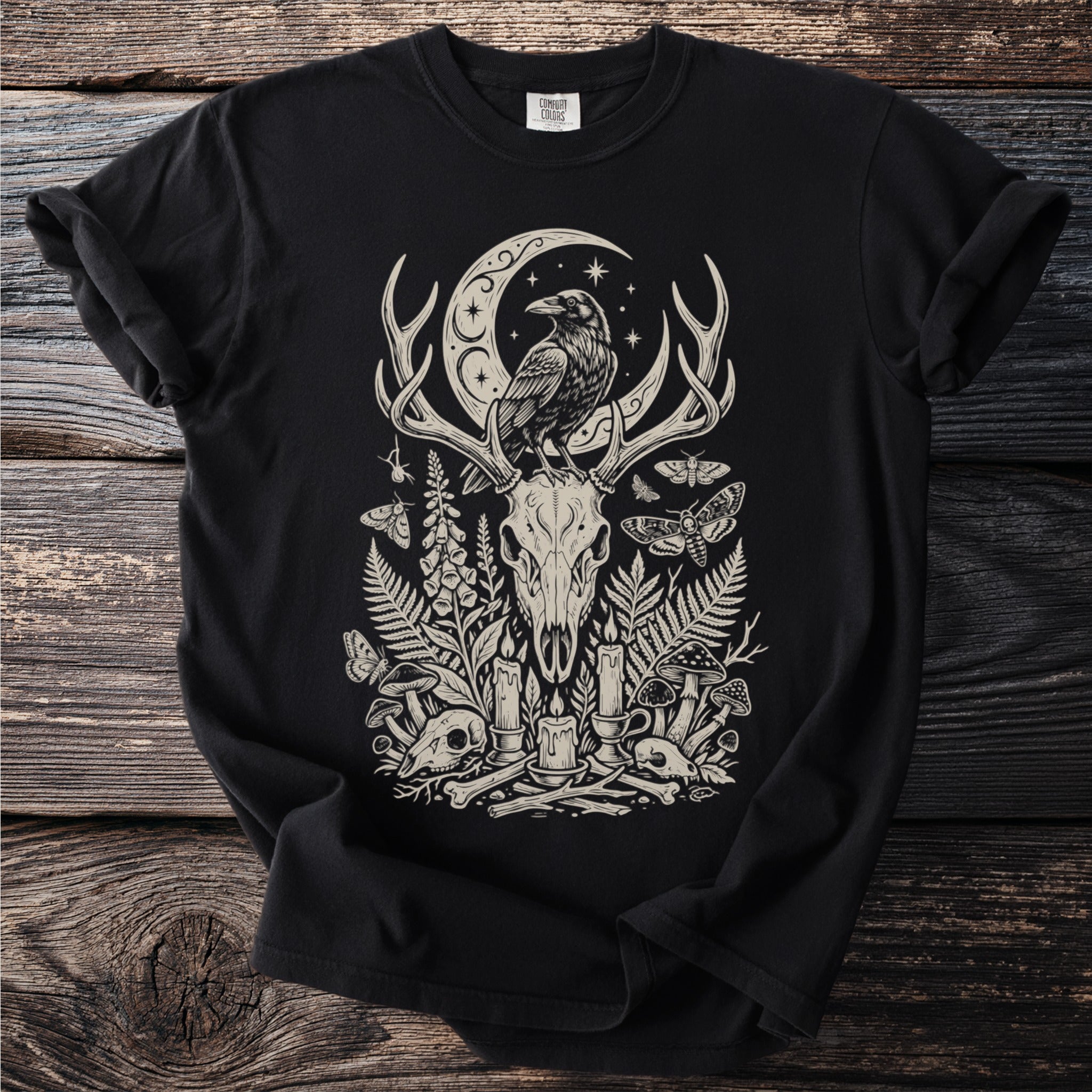 Black t-shirt with a detailed off-white graphic of a raven on antlers surrounded by skulls and nature elements.
