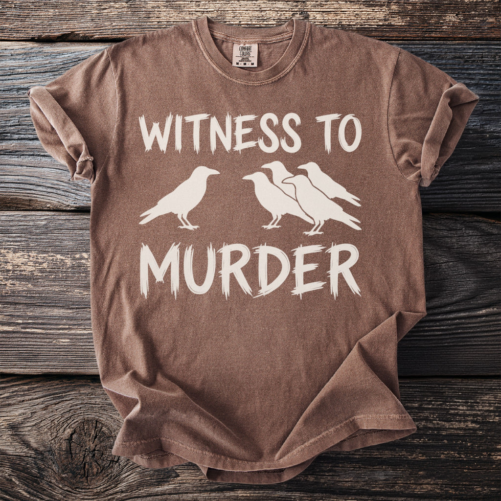 Brown t-shirt with white text "WITNESS TO MURDER" and silhouettes of four crows.