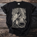 Witch stirring cauldron with raven and herbs, black t-shirt graphic.