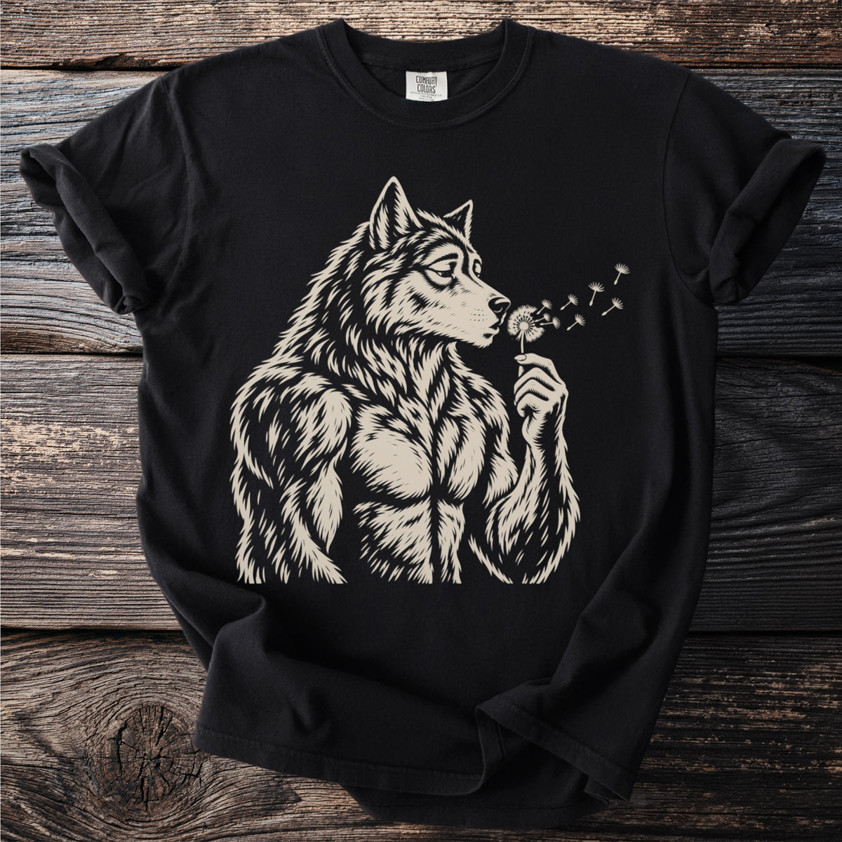 Black t-shirt with a detailed illustration of a muscular wolf blowing dandelion seeds.