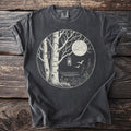 Dark t-shirt with a circular graphic of a moonlit forest scene with birches and a lantern.