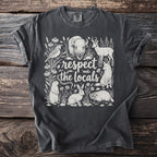 T-shirt with "respect the locals" text and illustrations of North American wildlife.