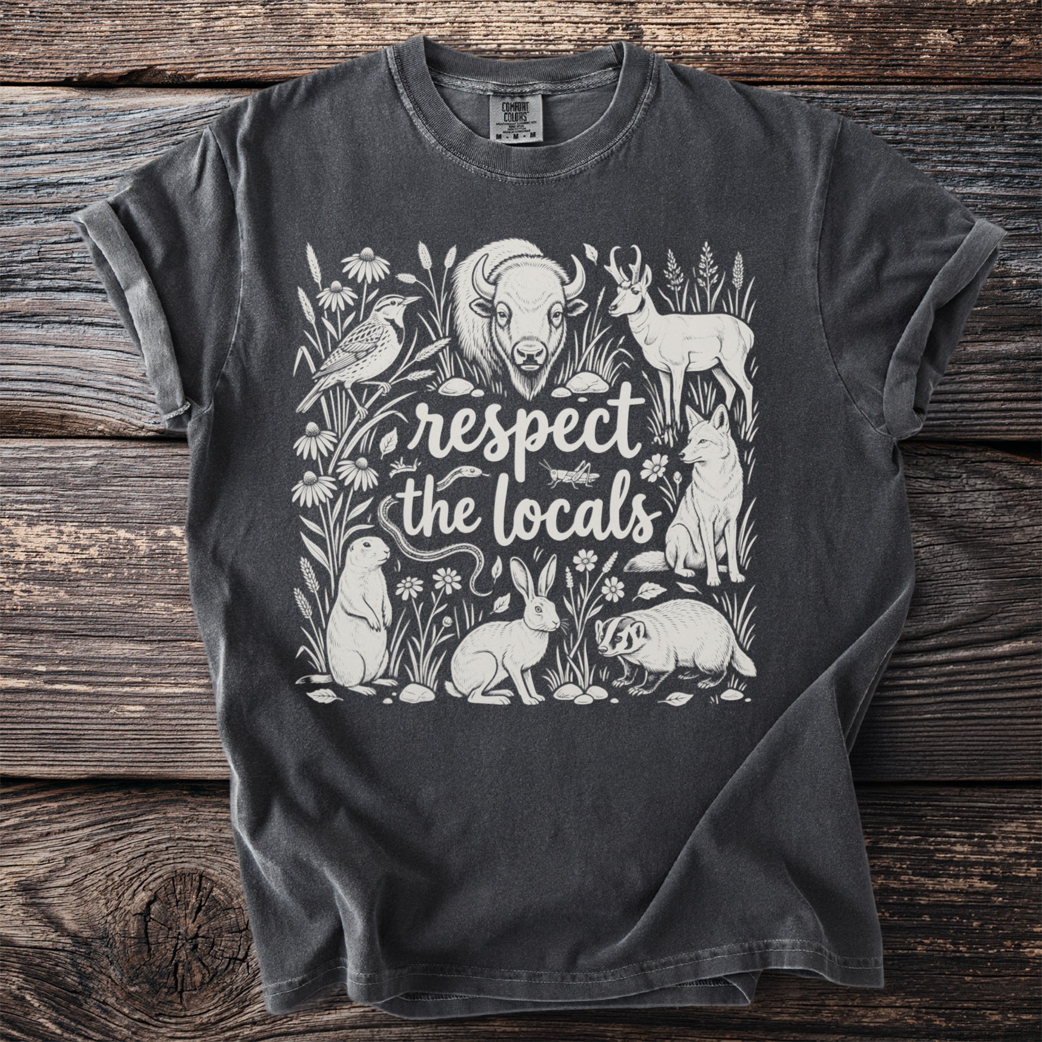 T-shirt with "respect the locals" text and illustrations of North American wildlife.