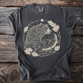 Dark t-shirt with a graphic of a bear and fish in water with leaves.