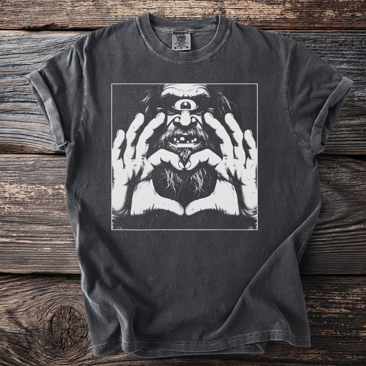 Black Comfort Colors t-shirt with graphic of a cyclops making a heart shape with its hands.