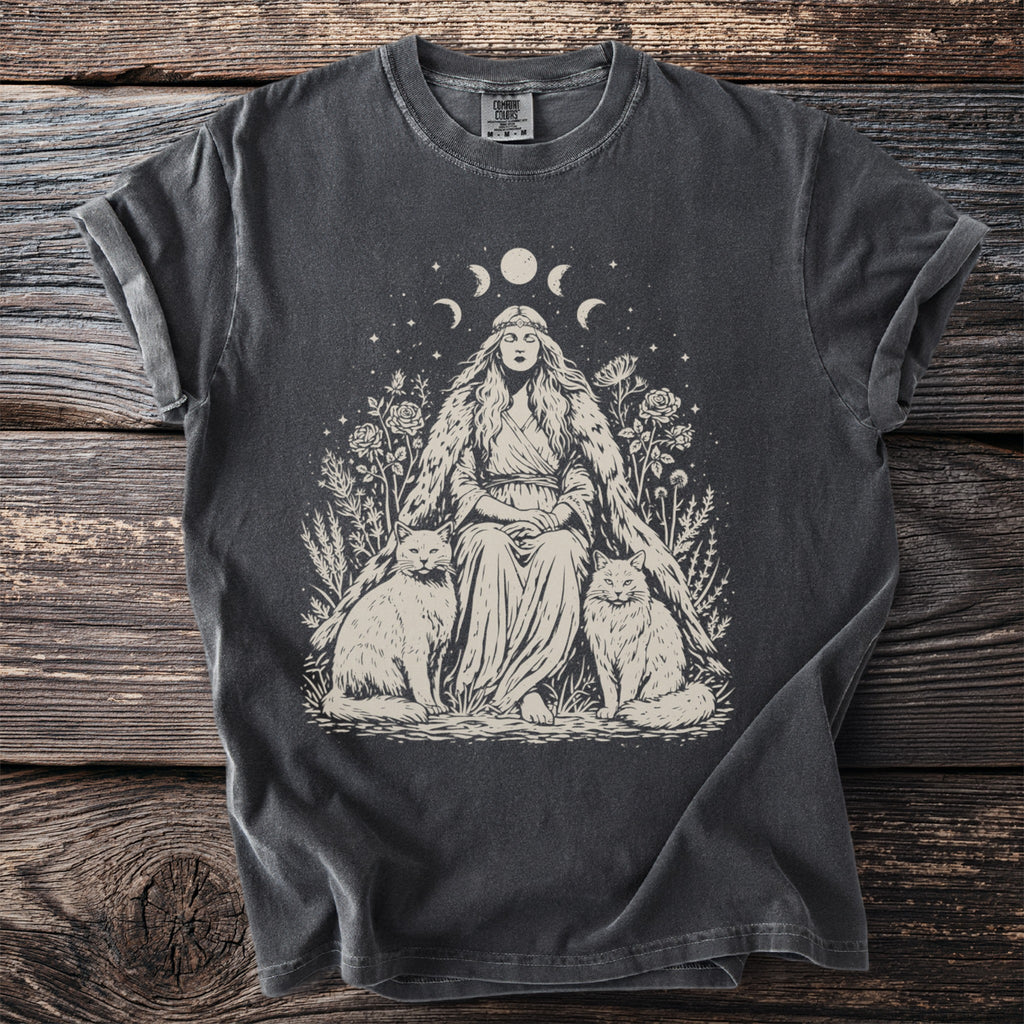 T-shirt with illustration of woman, two cats, roses, and moon phases.