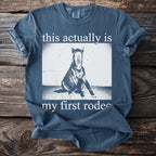 Blue t-shirt with a horse sitting and text "this actually is my first rodeo".