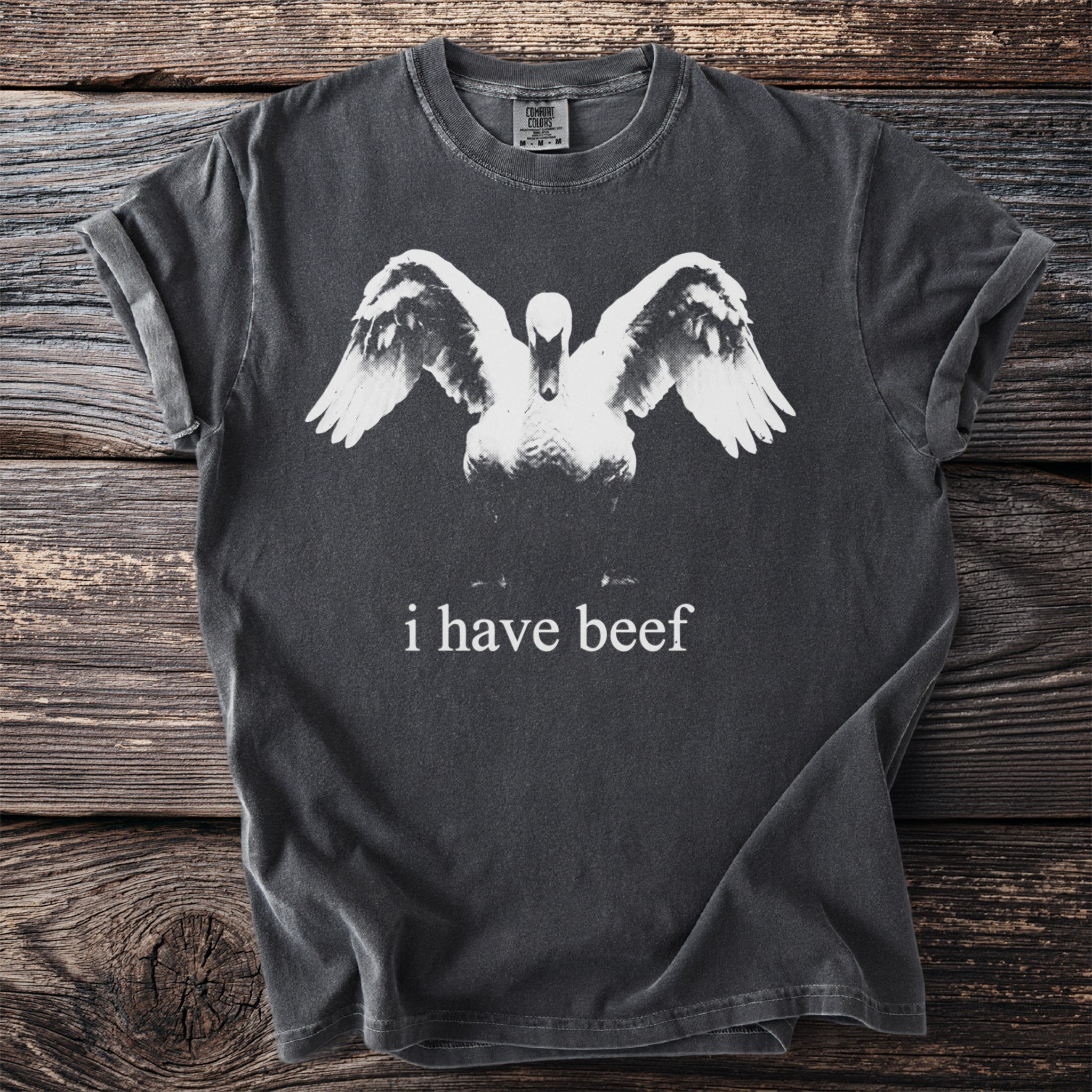 Dark grey t-shirt with a swan graphic and text "i have beef".