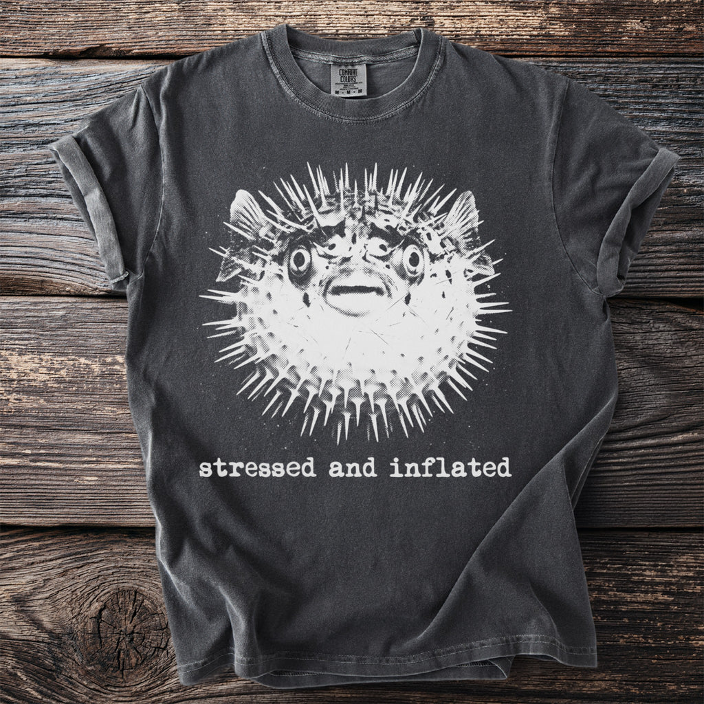 Charcoal t-shirt with a graphic of a pufferfish and the text "stressed and inflated".