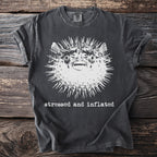 Charcoal t-shirt with a graphic of a pufferfish and the text "stressed and inflated".