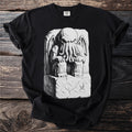 Black t-shirt with a monochromatic illustration of a tentacled creature sitting on a stone block.