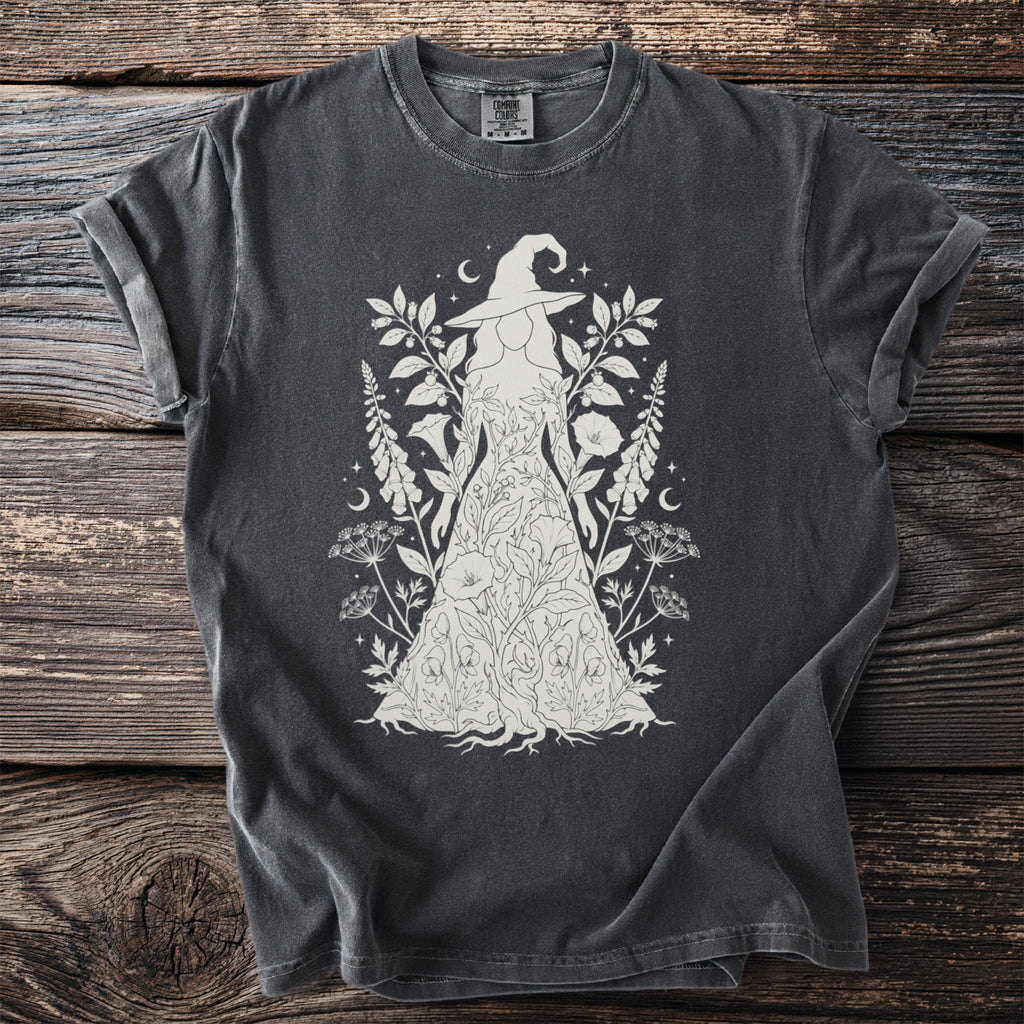 T-shirt with white linework illustration of a witch adorned with flowers and leaves.
