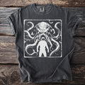 Dark t-shirt with a graphic of a menacing octopus and a silhouette of an astronaut.