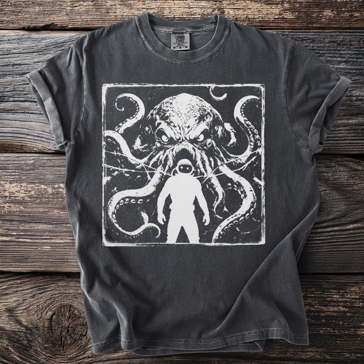 Dark t-shirt with a graphic of a menacing octopus and a silhouette of an astronaut.