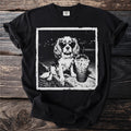 Black t-shirt with a vintage-style graphic of a dog wearing sunglasses next to a drink.