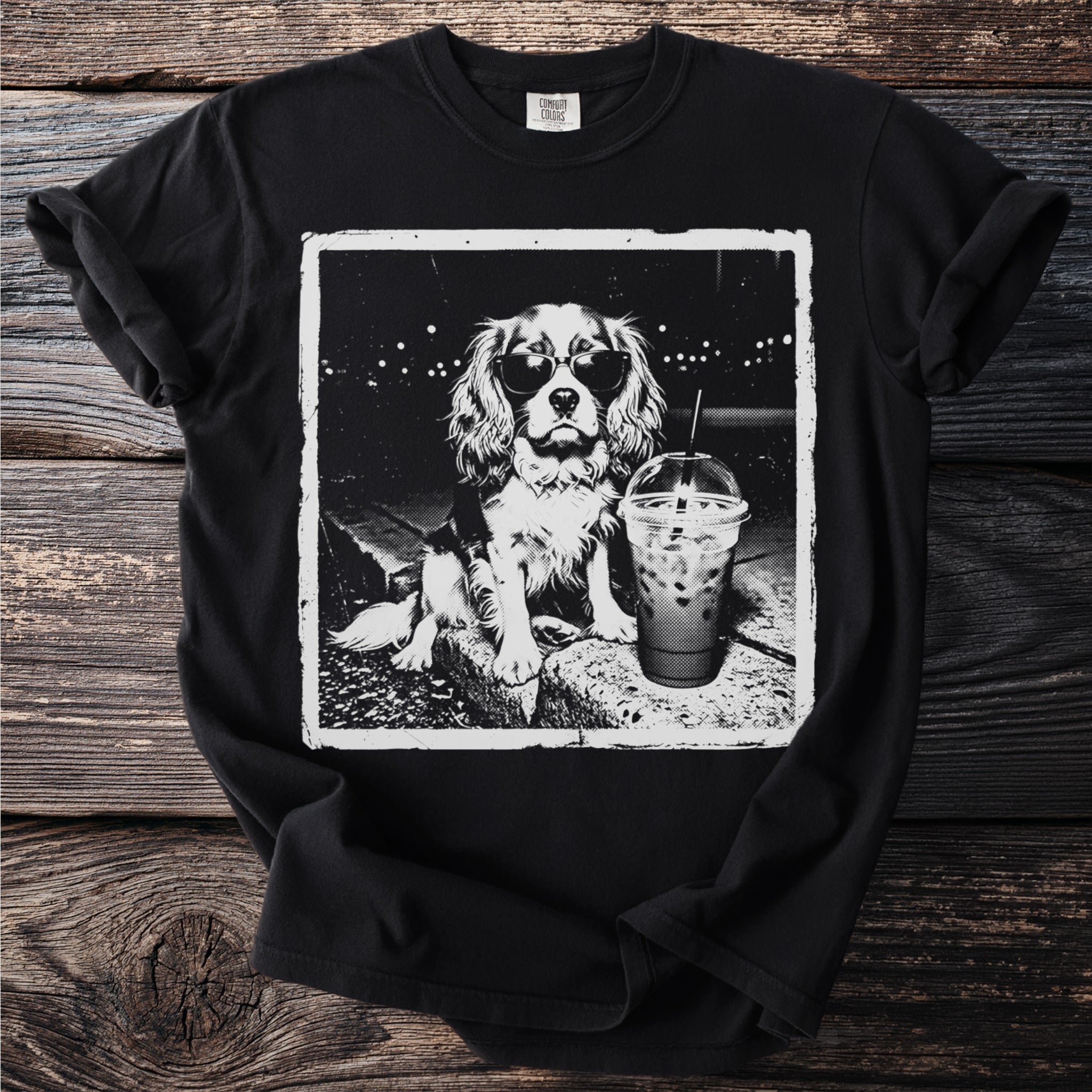 Black t-shirt with a vintage-style graphic of a dog wearing sunglasses next to a drink.