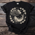 Black t-shirt with a circular graphic of a bear and fish surrounded by leaves and a moon.