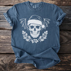 Blue t-shirt with white Christmas skull, bat wings, and holly wreath graphic.