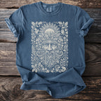 Blue t-shirt with a nature-themed print of a green man, sun, owl, squirrel, and hedgehogs.