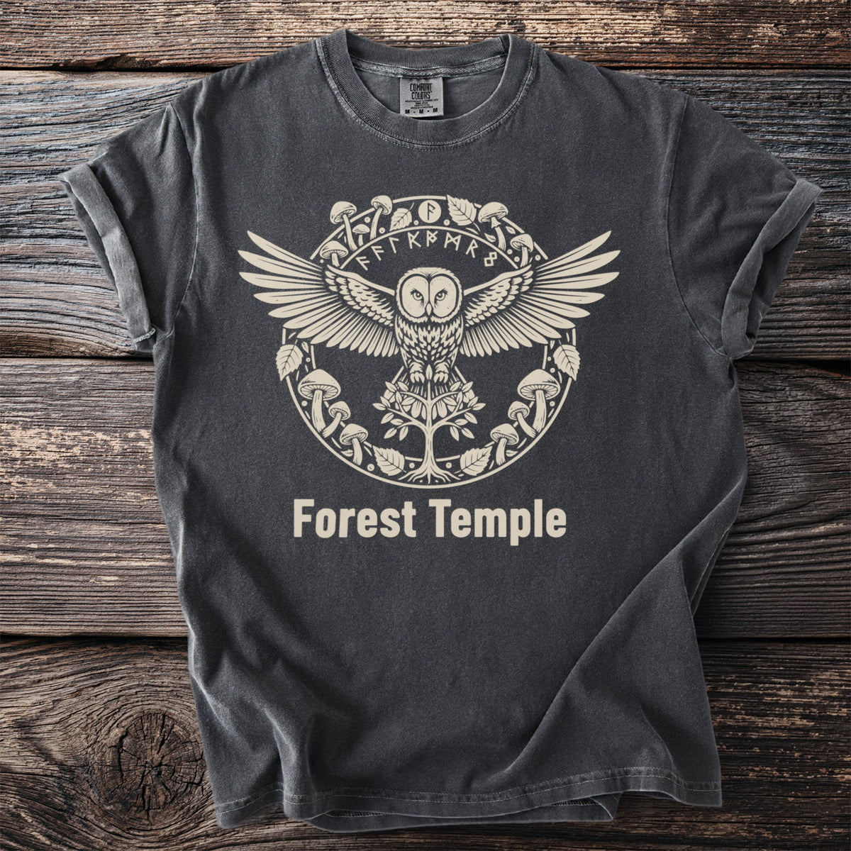 Dark t-shirt with cream graphic of an owl, runes, mushrooms, and "Forest Temple" text.