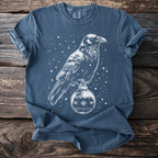 Blue t-shirt with a line drawing of a raven on a Christmas ornament.