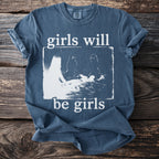 Blue t-shirt with white text "girls will be girls" and graphic of figures.