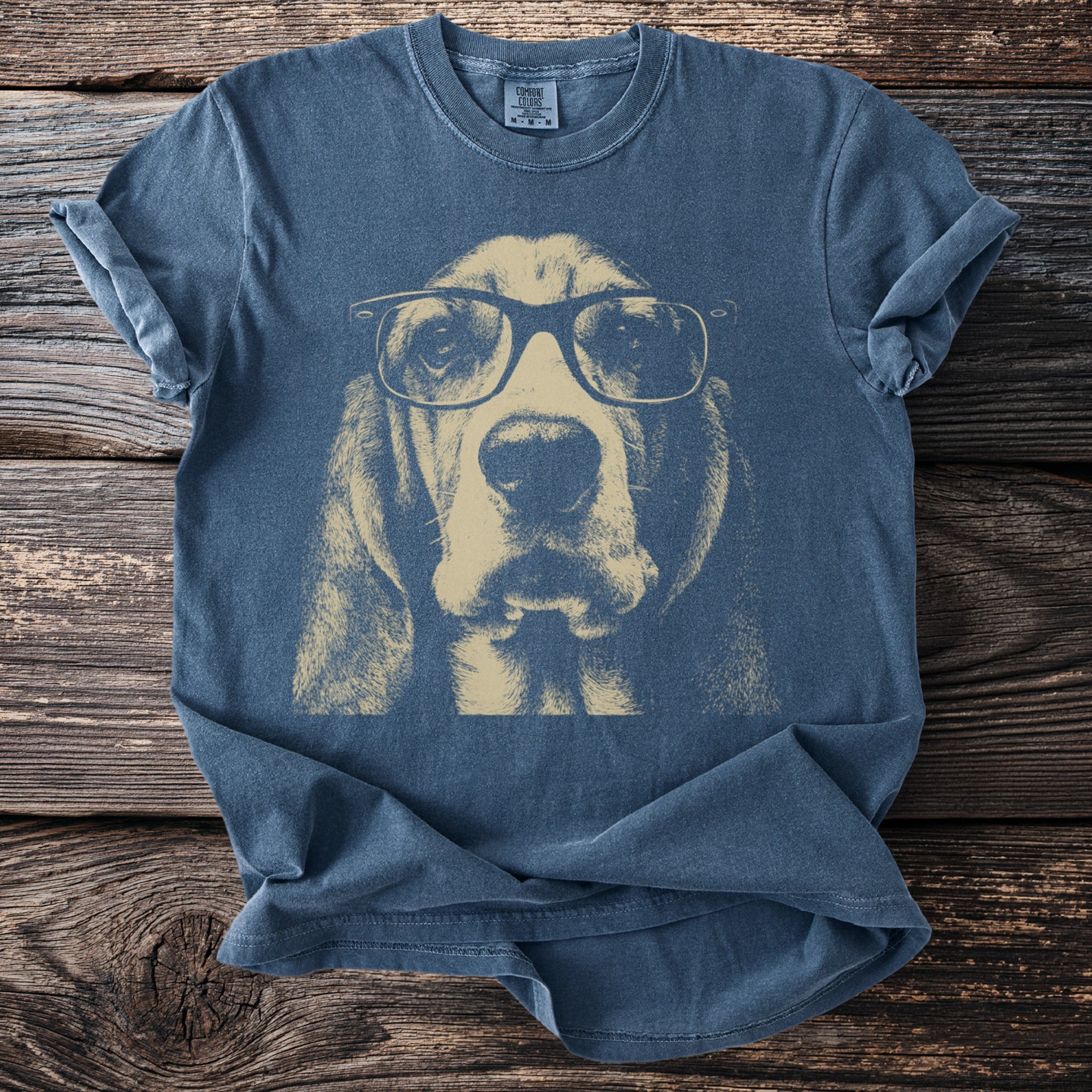 T-shirt with a graphic of a tan Basset Hound wearing black-rimmed glasses.