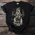 Black t-shirt with a botanical witch design and labeled plants.