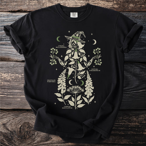 Black t-shirt with a botanical witch design and labeled plants.
