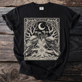 Black t-shirt with a graphic featuring two ravens, a tree, a crescent moon, and runes.
