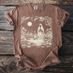 Brown t-shirt with a cream-colored graphic of a cloaked figure at a moonlit pond.