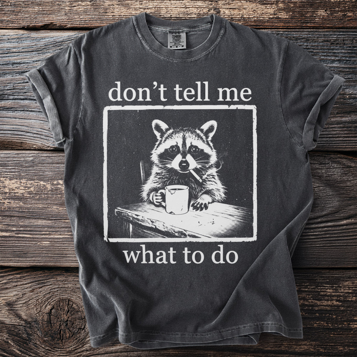 Dark grey t-shirt with raccoon smoking and holding coffee cup, "don't tell me what to do."