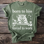 Green t-shirt with "born to hiss forced to work" text and a grumpy cat at a keyboard graphic.